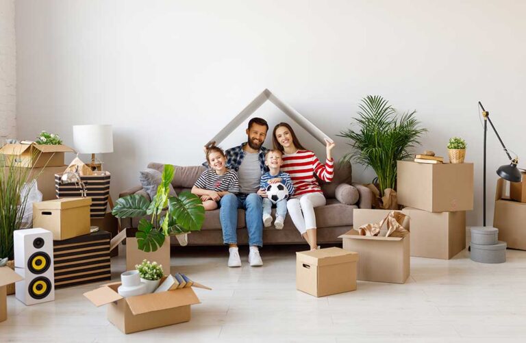 Family organizes moving boxes and household documents inside a newly occupied home.
